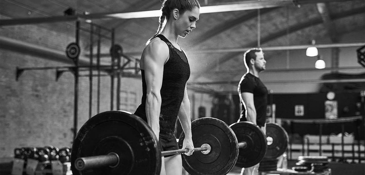 Athletes deadlifting in a gym