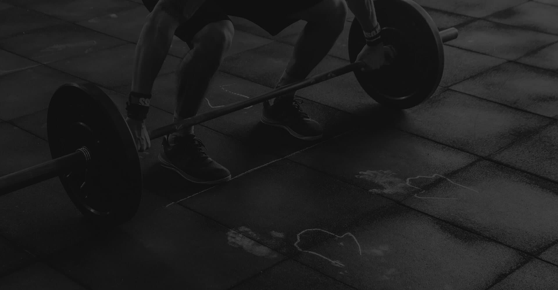 Athlete gripping a loaded barbell