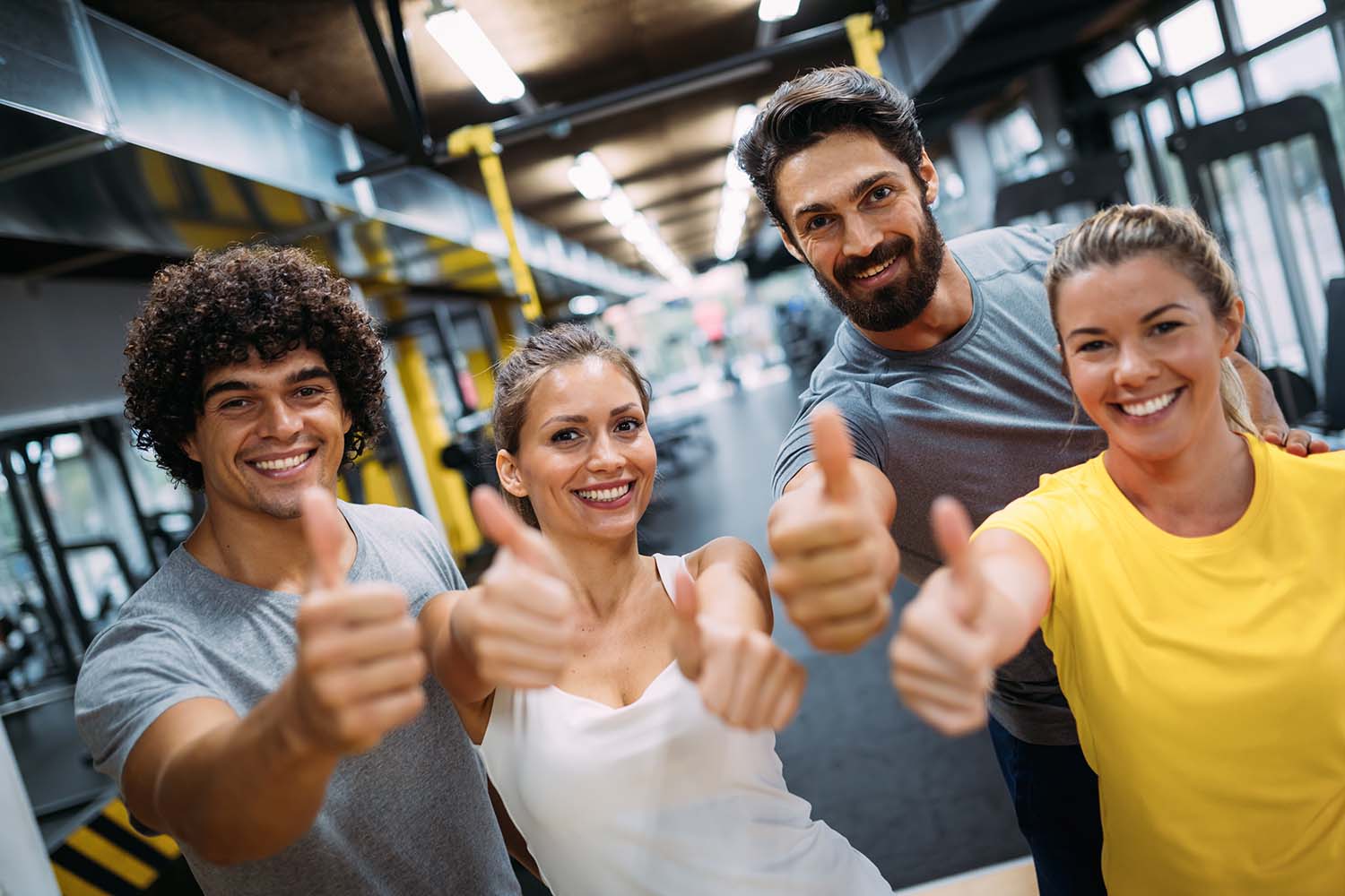 Double Circle team giving a thumbs up in the gym