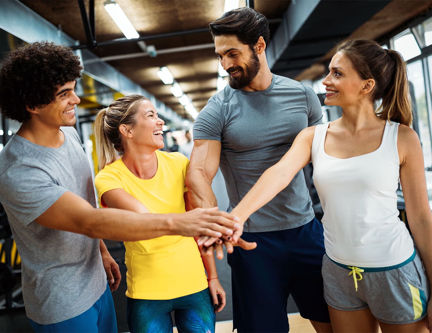 Training partners stacking hands before a workout